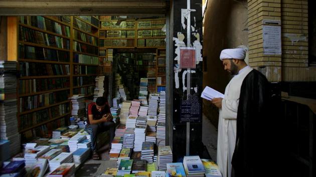 A Shi'ite cleric reads a book at a library in Najaf, south of Baghdad, Iraq. Students are given instruction in subjects including Islamic jurisprudence, philosophy, theology, logic and interpreting Islam’s holy book, the Quran. (Abdullah Dhiaa Al-deen / REUTERS)