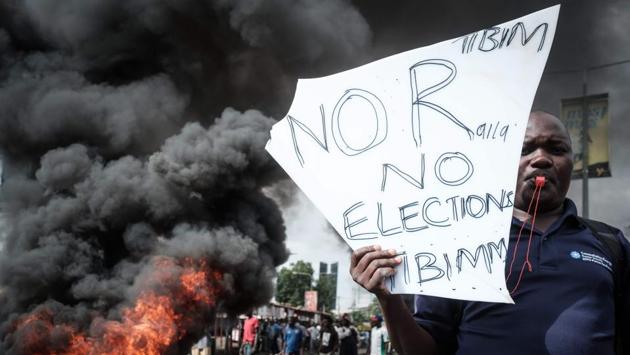 An opposition supporter holds a placard during their protest against Independent Electoral and Boundaries Commission (IEBC) officials over claims of bungling the August presidential vote, which was nullified by the Supreme Court, in Kisumu, Kenya, on October 11, 2017. (Yasuyoshi Chiba / AFP) An opposition supporter holds a placard during their protest against Independent Electoral and Boundaries Commission (IEBC) officials over claims of bungling the August presidential vote, which was nullified by the Supreme Court, in Kisumu, Kenya, on October 11, 2017. (Yasuyoshi Chiba / AFP)