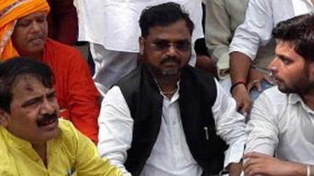 In a video that went viral, Robertsganj parliamentarian Chhote Lal Kharwar (in the middle) was heard making derogatory remarks against police at a protest meeting.(HT Photo)
