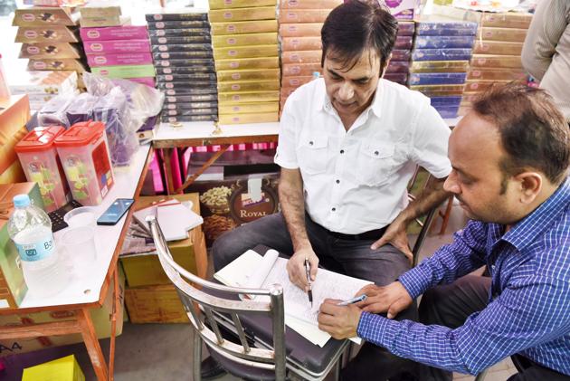 KK Sharma, Gurgaon food safety officer, checks samples at a city sweet shop. (Sanjeev Verma/HT PHOTO) KK Sharma, Gurgaon food safety officer, checks samples at a city sweet shop. (Sanjeev Verma/HT PHOTO)