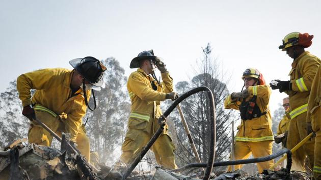 Firefighters search through the remains of a home in the Fountaingrove neighborhood for a strongbox and a wedding ring on October 13 in Santa Rosa, California. (AFP Photo) Firefighters search through the remains of a home in the Fountaingrove neighborhood for a strongbox and a wedding ring on October 13 in Santa Rosa, California. (AFP Photo)
