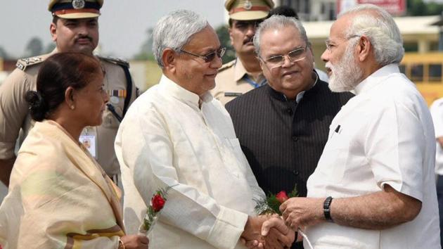 Bihar chief minister Nitish Kumar welcomes Prime Minister Narendra Modi, while governor Satya Pal Malik looks on, in Patna on Saturday. (PTI Photo) Bihar chief minister Nitish Kumar welcomes Prime Minister Narendra Modi, while governor Satya Pal Malik looks on, in Patna on Saturday. (PTI Photo)