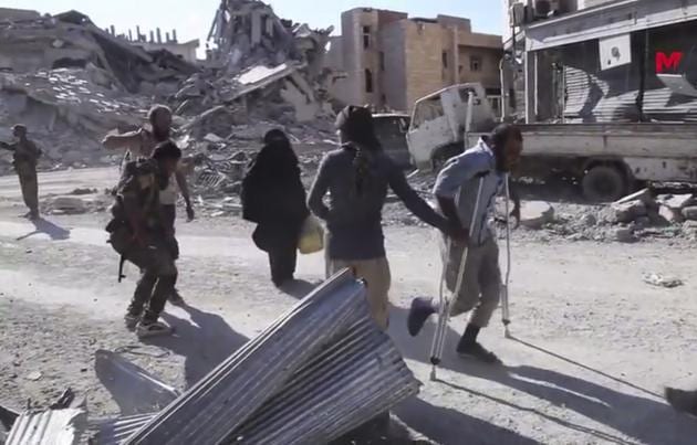 This frame grab from a video provided on Friday, October 13, 2017 by Turkey-based Kurdish Mezopotamya agency media outlet that is consistent with independent AP reporting, shows Syrian civilians flee from the areas that still controlled by the Islamic State militants, in Raqqa, Syria. (AP Photo) This frame grab from a video provided on Friday, October 13, 2017 by Turkey-based Kurdish Mezopotamya agency media outlet that is consistent with independent AP reporting, shows Syrian civilians flee from the areas that still controlled by the Islamic State militants, in Raqqa, Syria. (AP Photo)