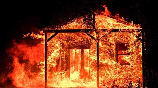 Flames overtake a structure as nearby homes burn in the Napa wine region in California as multiple wind-driven fires continue to whip through the region. (AFP Photo)
