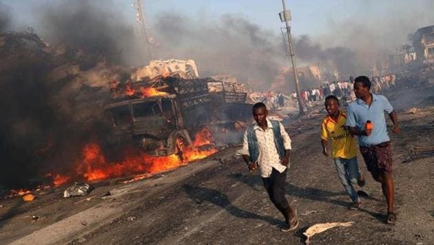 Civilians evacuate from the scene of an explosion in KM4 street in the Hodan district of Mogadishu, Somalia. (Reuters) Civilians evacuate from the scene of an explosion in KM4 street in the Hodan district of Mogadishu, Somalia. (Reuters)