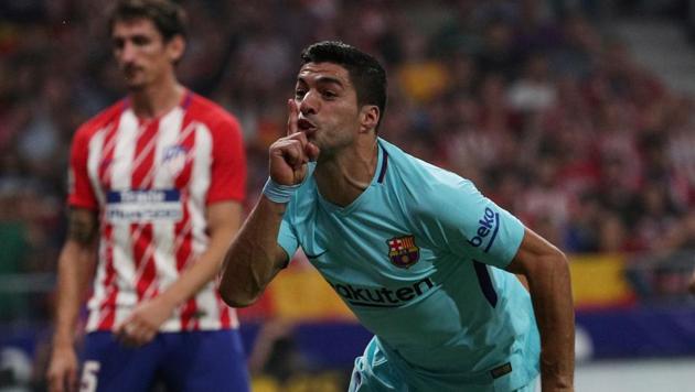 Barcelona’s Luis Suarez celebrates scoring their first goal against Atletico Madrid on Saturday.(Reuters)