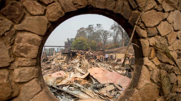 Signorello Estate Winery owner Ray Signorello (R), who flew in from Canada, views the remains of his winery in Napa, California. (AFP Photo)