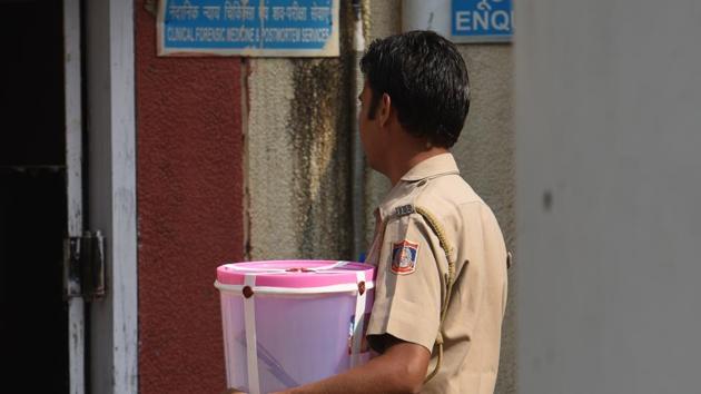 A Delhi Police officer carries the meat cleaver that was apparently used to kill 30-year-old Vipin Joshi and chop his body iN Saket. (Sanchit Khanna/HT PHOTO) A Delhi Police officer carries the meat cleaver that was apparently used to kill 30-year-old Vipin Joshi and chop his body iN Saket. (Sanchit Khanna/HT PHOTO)