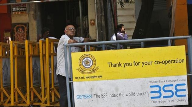 A man looks at a screen across the road displaying the Sensex on the facade of the Bombay Stock Exchange (BSE) building in Mumbai. (Reuters File) A man looks at a screen across the road displaying the Sensex on the facade of the Bombay Stock Exchange (BSE) building in Mumbai. (Reuters File)