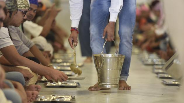 The langar is run by sevadars --volunteers doing selfless service-- Sikhs and others willing to help. This community kitchen invites participation from all. The function of Seva results in a sense of community among people and aims to break barriers of discrimination. (Raj K Raj / HT Photo)
