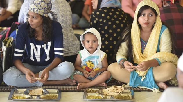 At Bangla Sahib, one of the most prominent Sikh places of worship in the country, the langar promotes decorum, with its equalizing concepts of sitting and dining in a community situation, regardless of age and gender. (Raj K Raj / HT Photo)