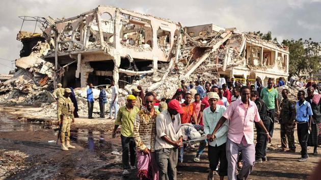 Somali men carry the body of a victim who died in the explosion. Doctors at hospitals in Mogadishu struggled to save the victims on Sunday. The Associated Press quoted one nurse as saying staff members had seen ‘unspeakable horrors’ in a hospital where the smell of blood was strong. (Mohamed Abdiwahab / AFP)