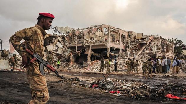 A Somali soldier patrols the scene of the explosion in the centre of Mogadishu. While there has been no immediate claim of responsibility, suspicion immediately fell on Al-Shabaab, a militant group aligned with Al-Qaeda, which has carried out dozens of similar bombings in its bid to overthrow Somalia’s internationally backed government. (Mohamed Abdiwahab / AFP)