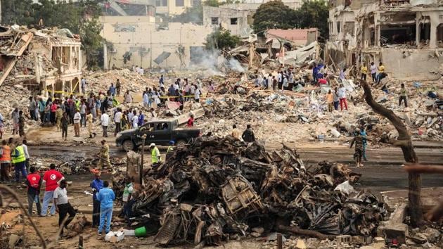 Fires continued to burn well into Sunday at the scene of the bombings. Abshir Ahmed, deputy speaker of the upper House of Parliament, wrote on his Facebook page that the director of one hospital had told him at least 130 bodies there were burnt beyond recognition. (Mohamed Abdiwahab / AFP)