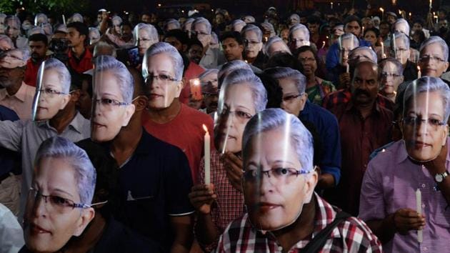 People wearing masks in a candle-light vigil to pay tribute to senior journalist and activist Gauri Lankesh in Thiruvananthapuram(PTI)