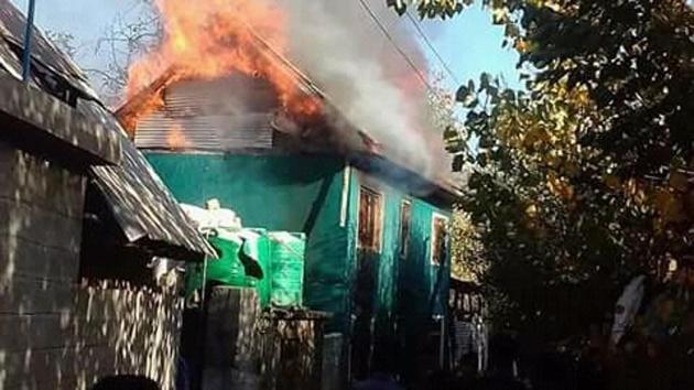 The house of the former sarpanch that was set on fire in Shopian. (ANI Twitter)