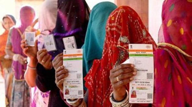 File photo of Rajasthani women showing their Aadhaar cards before a vote in Ajmer.