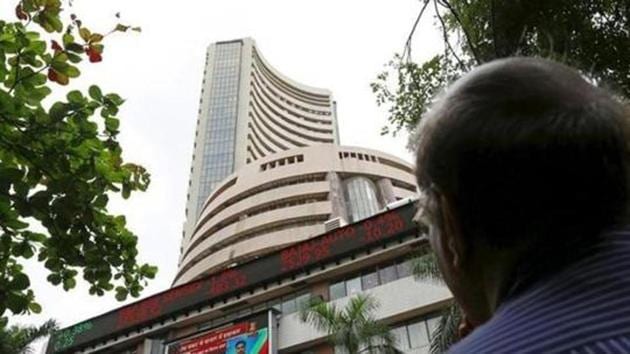 File photo of a man looks at a screen across a road displaying the Sensex on the facade of the Bombay Stock Exchange (BSE) building in Mumbai, India. (Reuters) File photo of a man looks at a screen across a road displaying the Sensex on the facade of the Bombay Stock Exchange (BSE) building in Mumbai, India. (Reuters)
