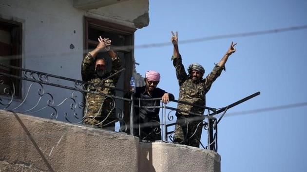 Fighters of Syrian Democratic Forces gesture the "V" sign at the frontline in Raqqa in Syria. (Reuters) Fighters of Syrian Democratic Forces gesture the "V" sign at the frontline in Raqqa in Syria. (Reuters)