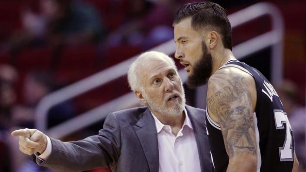 San Antonio Spurs head coach Gregg Popovich talks with Spurs forward Joffrey Lauvergne (77) in the second half of an NBA pre-season basketball game against the Houston Rockets Friday, Oct. 13, 2017, in Houston. (AP) San Antonio Spurs head coach Gregg Popovich talks with Spurs forward Joffrey Lauvergne (77) in the second half of an NBA pre-season basketball game against the Houston Rockets Friday, Oct. 13, 2017, in Houston. (AP)