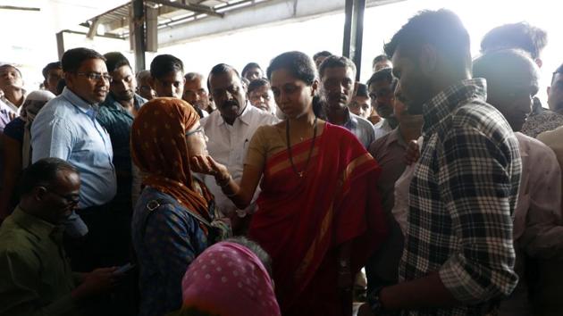 MPSupriya Sule interacts with commuters who were stranded following the bus strike at Swargate bus depot on Tuesday. (Rahul Raut/HT PHOTO) 