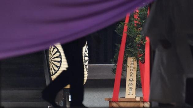 A wooden plaque showing the name of Japanese Prime Minister Shinzo Abe is seen with a "masakaki" tree that he sent as an offering to the controversial Yasukuni Shrine in Tokyo on October 17. (AFP Photo) A wooden plaque showing the name of Japanese Prime Minister Shinzo Abe is seen with a "masakaki" tree that he sent as an offering to the controversial Yasukuni Shrine in Tokyo on October 17. (AFP Photo)