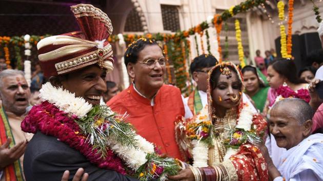 Rakesh Kumar (left) smiles at the solemnization of his marriage to Vinita Devi in Vrindavan. They had a court marriage in 2014 but lacked societal acceptance, hence Sulabh International stepped in to help them with the ceremonial rituals. (Burhaan Kinu / HT Photo)