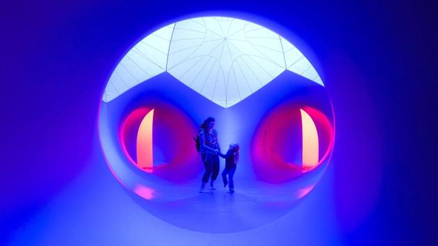 Visitors dance under a dome while browsing the ‘Luminarium’ designed by artist Alan Parkinson as part of the ‘Architects of Air’ installation at Washington Park for the BLINK festival in downtown Cincinnati. (John Minchillo / AP)