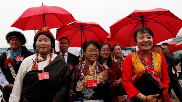 Delegates in traditional costumes arrive for the National Congress at the Great Hall of the People in Beijing. ‘Through a long period of hard work, socialism with Chinese characteristics has entered a new era, this is a new historical direction in our country’s development,’ Xi said in the speech carried live across the nation on state television. (Tyrone Siu / REUTERS)