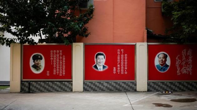 Pictures of late People's Liberation Army soldier Lei Feng, Chinese President Xi Jinping and late Chinese Chairman Mao Zedong overlook a courtyard in Shanghai, China. (Reuters) Pictures of late People's Liberation Army soldier Lei Feng, Chinese President Xi Jinping and late Chinese Chairman Mao Zedong overlook a courtyard in Shanghai, China. (Reuters)