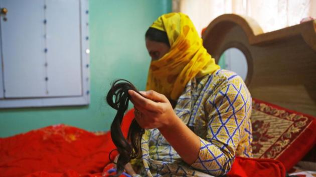 A woman displays her hair which chopped on October 8, 2017, in Batamalloo area of Srinagar.(Waseem Andrabi/HT File Photo)