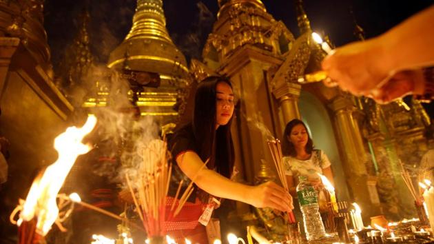 Women light incense sticks for prayer during the Thadingyut full moon day festival (festival of lights) at the Shwedagon pagoda in Yangon, Myanmar. (Soe Zeya Tun / Reuters)