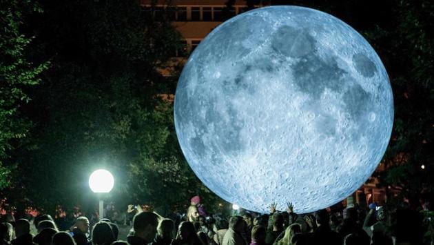 People watch a light object called ‘The Museum of the Moon’ created by British artist Luke Jerram, which was displayed at the Medical Garden during the White Night festival in Bratislava, Slovakia. The Museum of the Moon will also be presented in Lee Tung Avenue, Hong Kong till October 31, 2017. (Joe Klamar / AFP)