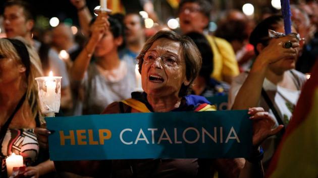 A woman holds a candle during a demonstration in Barcelona against the arrest of two Catalan separatist leaders on October 17. (AFP Photo) A woman holds a candle during a demonstration in Barcelona against the arrest of two Catalan separatist leaders on October 17. (AFP Photo)