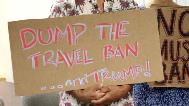 Critics of President Donald Trump's travel ban hold signs during a news conference in Honolulu. (AP Photo) Critics of President Donald Trump's travel ban hold signs during a news conference in Honolulu. (AP Photo)