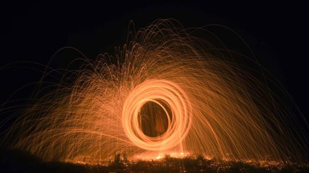For capturing a steel wool light trail, steel wool is set on fire and is then spun, following which it creates a sort of visual distortion. (Pratham Gokhale/HT Photo) 