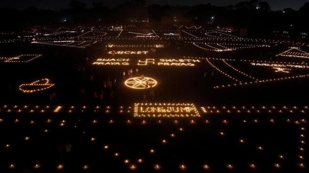 People light candles in a stadium as part of Diwali, the Hindu festival of lights, celebrations in Allahabad. (Jitendra Prakash / REUTERS)