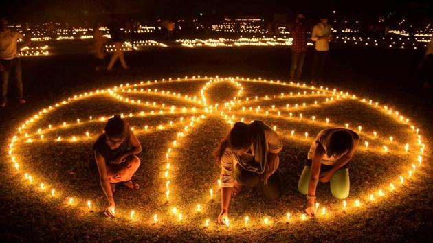 Young Hockey players light candles in an elaborate formation at Madan Mohan Malviya Stadium during Diwali festival celebration in Allahabad, Uttar Pradesh. (PTI)