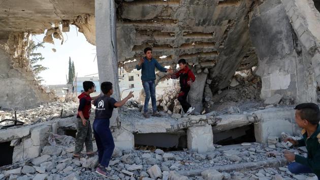 Children play at the ruins of a building destroyed in an air strike during anti ISIS offensives in Kobani, Syria on October 11, 2017. This city may offer a glimpse into what lies ahead for areas where ISIS only recently was driven out. Kurdish fighters fought fiercely here, early in 2015. Nearly three years later, roads are still being repaved, reconstruction has been slow and only a fraction of the prewar population has returned. (Erik De Castro / REUTERS)