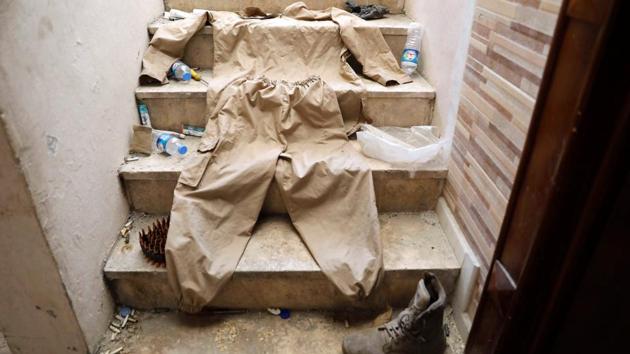 A uniform of a member of Islamic State militants is pictured as it was displayed by the SDF at their positions inside a building captured at the frontline in Raqqa during the final offensive on October 6, 2017. Fleeing jihadis are regrouping in remote areas, rearming with the help of desert smugglers. Tensions also brew over who will ultimately control Raqqa and if ISIS will now resort to guerilla tactics. (Erik De Castro / REUTERS)