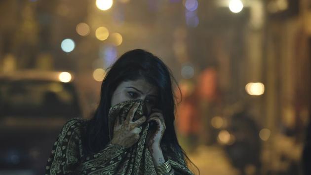 A girl protects her face amid heavy smog due to bursting of firecrackers in New Delhi. Even though firecrackers were burst in most parts of the city, the noise level was much less due to lack of easy availability. (Raj K Raj/HT PHOTO)