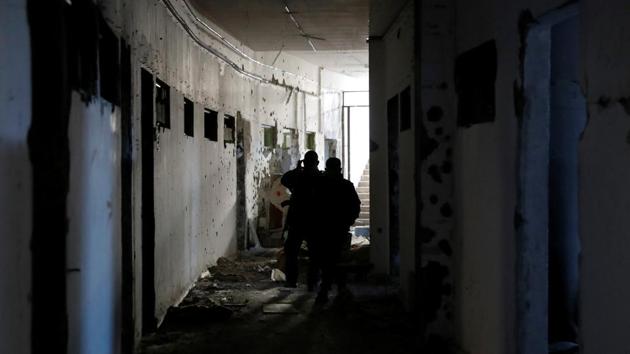 SDF fighters inspect the bunker of the Islamic State militants under the stadium in Raqqa, Syria on October 18, 2017. The stadium also served as one of the largest jails operated by ISIS and an arms depot for the group. (Erik De Castro / REUTERS)