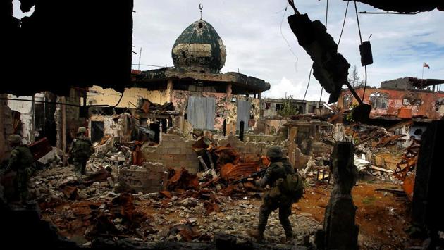 Government soldiers from the Philippine Marines 1st Brigade patrol past damaged buildings during clearing operations in Marawi, on September 14, 2017. Marawi has been the homeland of minority Muslims and the scene of a decades-old separatist rebellion. The Philippine government’s response meant to deal with the uprising and prevent other insurgents from waging attacks elsewhere and reinforcing existing fighters in Marawi. (Marconi Navales / REUTERS)