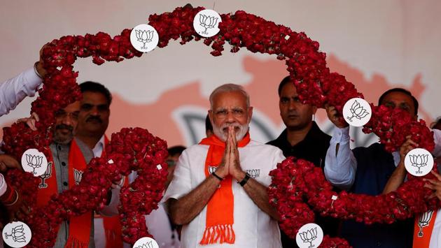 India's Prime Minister Narendra Modi is garlanded by supporters during a public rally at Bhaat village on the outskirts of Ahmedabad. (Amit Dave / REUTERS)