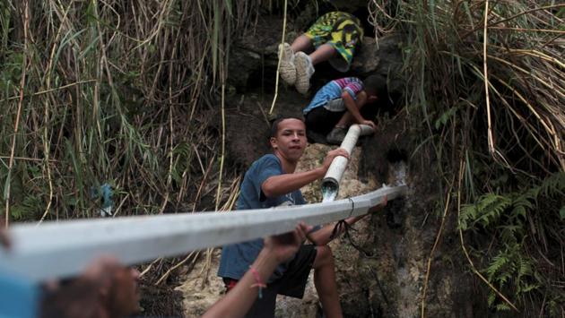 People collect mountain spring water, after Hurricane Maria hit the island, in Corozal, Puerto Rico. (Alvin Baez / REUTERS)