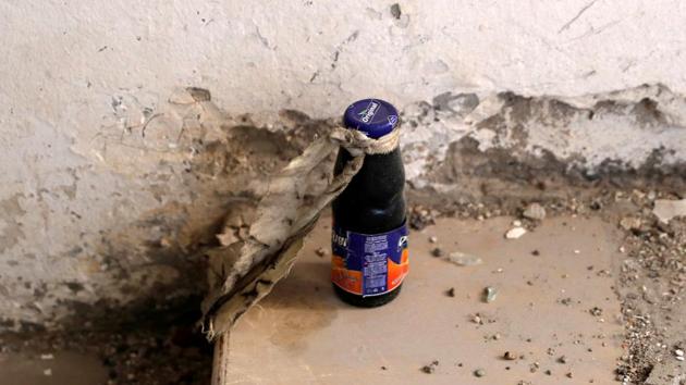 An unexploded bomb inside a juice bottle is pictured near the bunker of the Islamic State militants under the stadium in Raqqa, Syria on October 18, 2017. (Erik De Castro / REUTERS)
