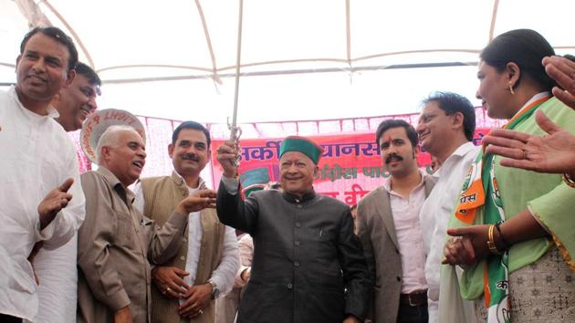 Himachal Pradesh chief minister Virbhadra Singh displaying a sword presented by Congress workers at a public meeting after filing his nominations for the November 9 Vidhan Sabha elections, in Arki constituency in Solan district on Friday. (Deepak Sansta/HT) Himachal Pradesh chief minister Virbhadra Singh displaying a sword presented by Congress workers at a public meeting after filing his nominations for the November 9 Vidhan Sabha elections, in Arki constituency in Solan district on Friday. (Deepak Sansta/HT)