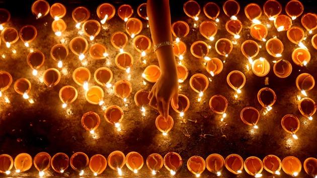 A devotee lights oil lamps at a religious ceremony during the Diwali or Deepavali festival at a Hindu temple in Colombo, Sri Lanka. (Dinuka Liyanawatte / REUTERS)