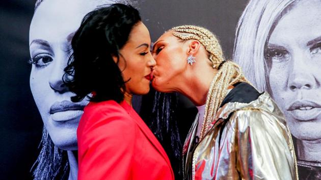 Swedish boxer Mikaela Lauren (R) kisses boxer Cecilia Braekhus of Norway during a news conference, ahead of their Oslofjord Fight Night in Oslo, Norway. (REUTERS)