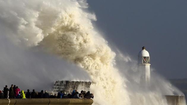 Huge waves strike the harbour wall and lighthouse at Porthcawl, South Wales as Storm Ophelia hits the UK and Ireland on October 16, 2017. Ireland was hit by an ‘unprecedented storm’ on Monday that left two people dead, 120,000 homes and businesses without power and closed every school in the country. (Geoff Caddick / AFP)